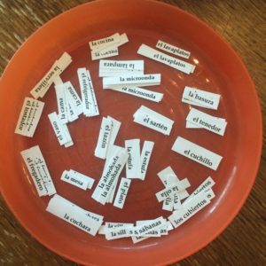 Here's an alt tag for the image: Spanish vocabulary words in a bowl.