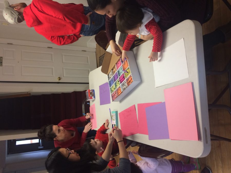 A group of people sitting around a table with paper.